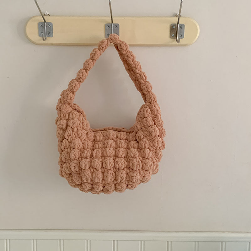 Handmade beige crochet straw bag with sturdy hand strap, perfect for seaside or beach vacation, by Bella Mia.