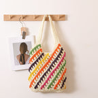 Colorful striped woven shoulder straw bag with cutout design, perfect for beach or casual summer vacations.