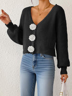 Women’s knitted cardigan by Bella Mia featuring floral buttons, short hipster style, hand hook detail, perfect for casual wear