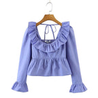Bella Mia summer wind women solid color long sleeve ruffled shirt displayed on a model with a breezy, stylish look