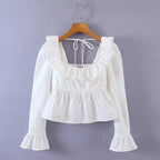 Bella Mia Summer Wind solid color long sleeve ruffled shirt for women, featuring a stylish and elegant design with ruffle details.