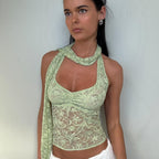 Women’s summer lace halterneck vest top by Bella Mia, see-through design with decorative ribbons and a stylish short fit.