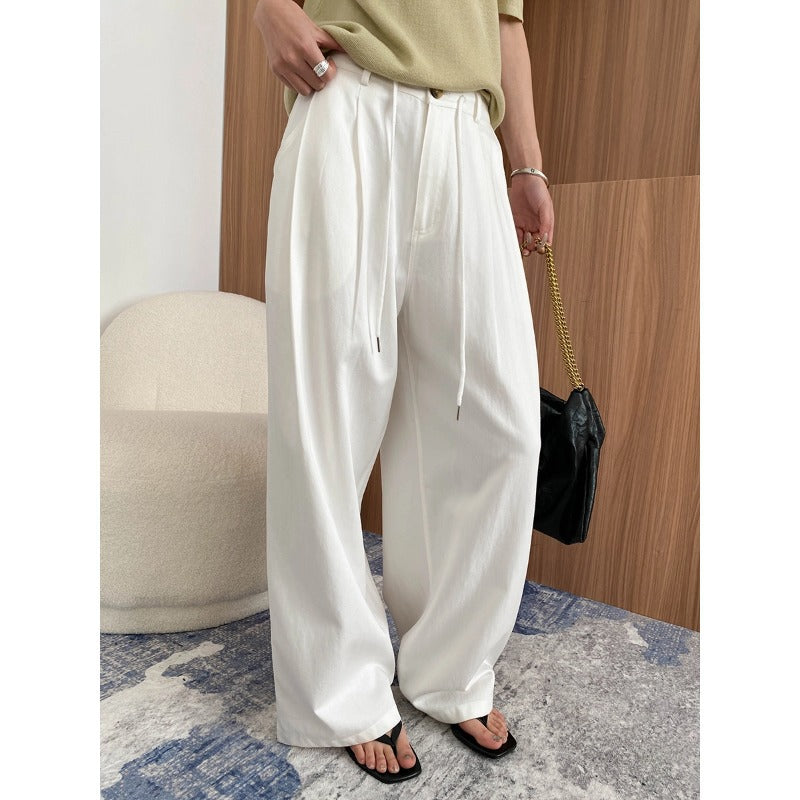 Close-up of Wanita Store's early autumn Tencel Lyocell pleated casual pants with drawstring and smooth draped design.