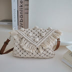 Bella Mia woven cotton beanie crossbody bag with tassels, straw design, ideal for beach or vacation use.