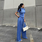Blue high-waist pleated wide-leg pants and casual T-shirt from Wanita Store, showcasing a stylish women's spring outfit.