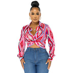 Women’s Bella Mia twist button shirt top with geometric pattern print, featuring a stylish design and button details.