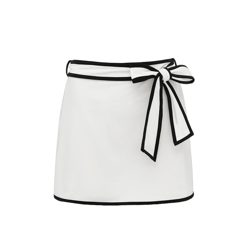 Black and white matching girl’s swimsuit with bow detail and white skirt, stylish swimwear for women by Plush Fashion Hub