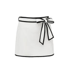 Black and white matching girl’s swimsuit with bow detail and white skirt, stylish swimwear for women by Plush Fashion Hub