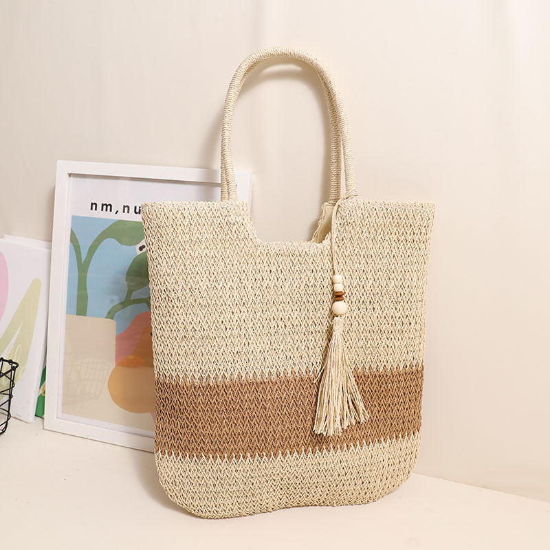 Woven two-tone tassel shoulder bag by Plush Fashion Hub, casual straw beach bag with fringe details for women.