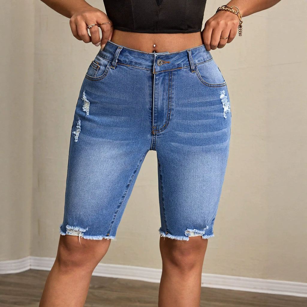 Women's denim tight shorts from Wanita Store, casual all-match style, close-up of fitted blue denim shorts.