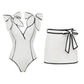 Black and white matching girl’s swimsuit with bow and white skirt, stylish swimwear for women by Plush Fashion Hub.