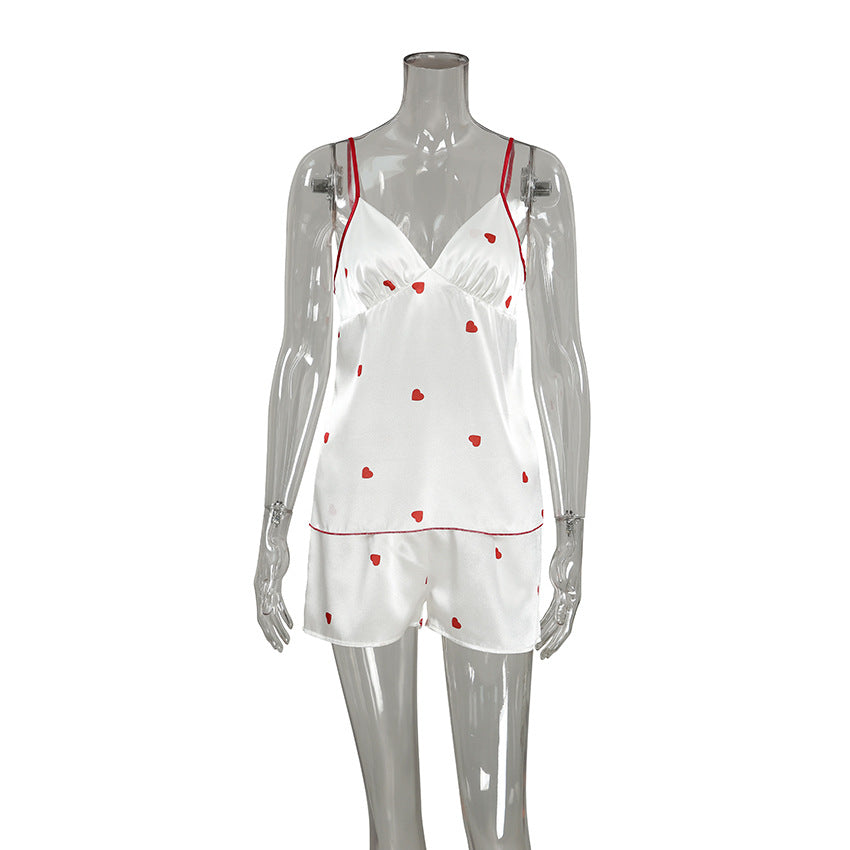 Bella Mia spring homewear set featuring satin suspender shorts and heart-print two-piece pajamas for women.