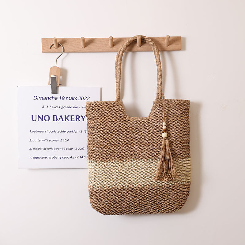 Woven two-tone tassel straw shoulder bag by Plush Fashion Hub, casual beach bag with woven texture and tassel accents.