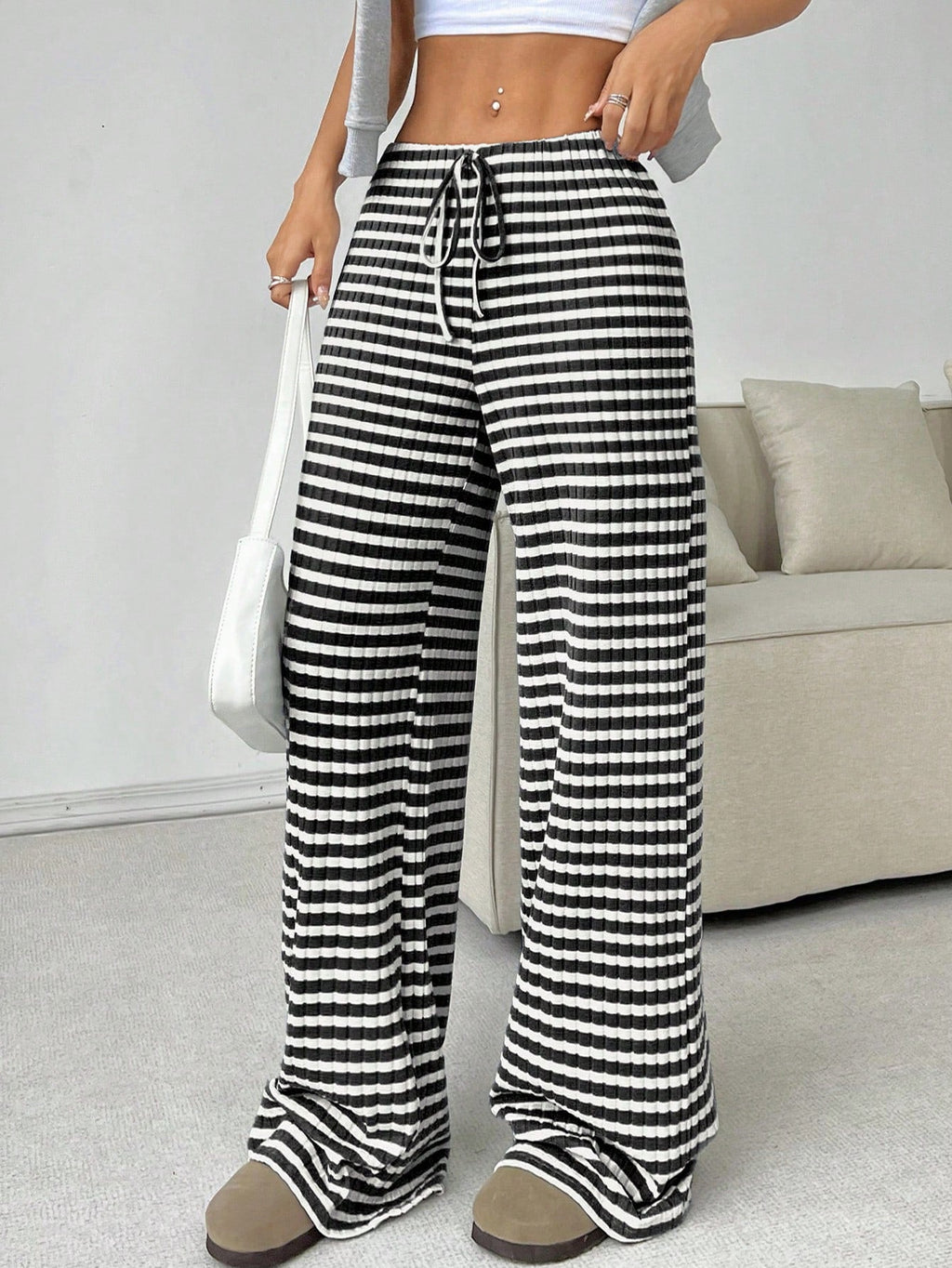 Casual women's striped solid color straight-leg pants with rubber band and drawstring, suitable for autumn and winter wear.