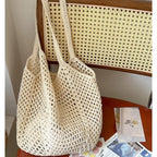 Large capacity cotton woven straw bag with hollow cutout design, ideal for beach and vacation, women's casual shoulder bag.