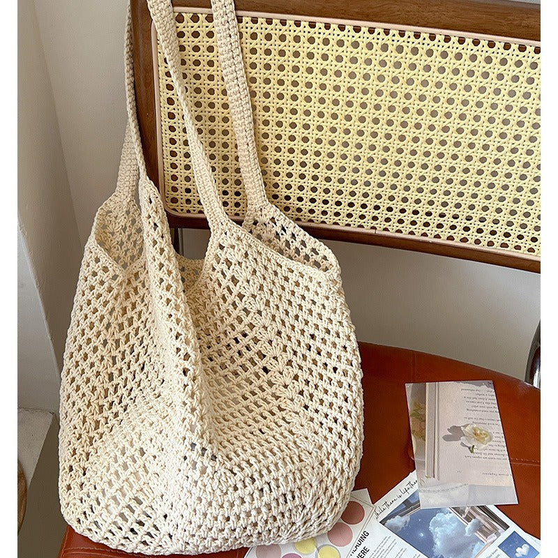 Large cotton woven straw bag with cutout design, ideal for beach or vacation, featuring a spacious shoulder bag style for women.