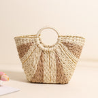Bella Mia large straw-weaved tote bag with contrast handles, perfect for beach, vacation, or vegetable basket use.