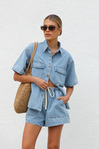 Casual women's summer denim short-sleeved two-piece set with loose fit and pockets, featuring a stylish top and matching shorts.
