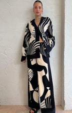 Women’s casual clothing set with printed design from Wanita Store, featuring comfortable matching top and pants.