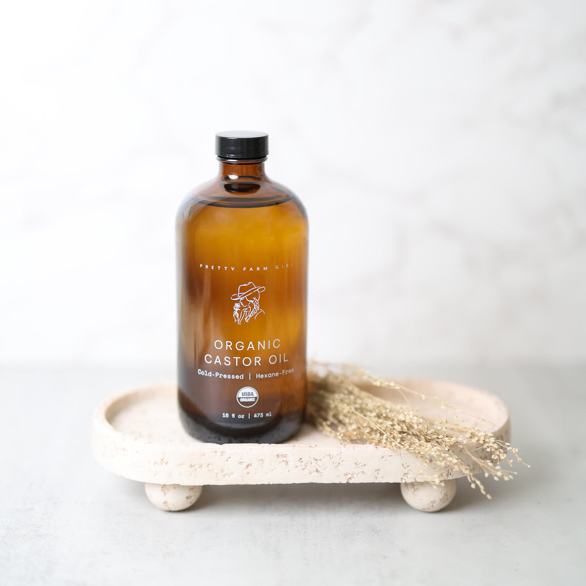 Organic castor oil by Pretty Farm Girl in a 16oz bottle, cold pressed and hexane-free for natural skincare and hair care.