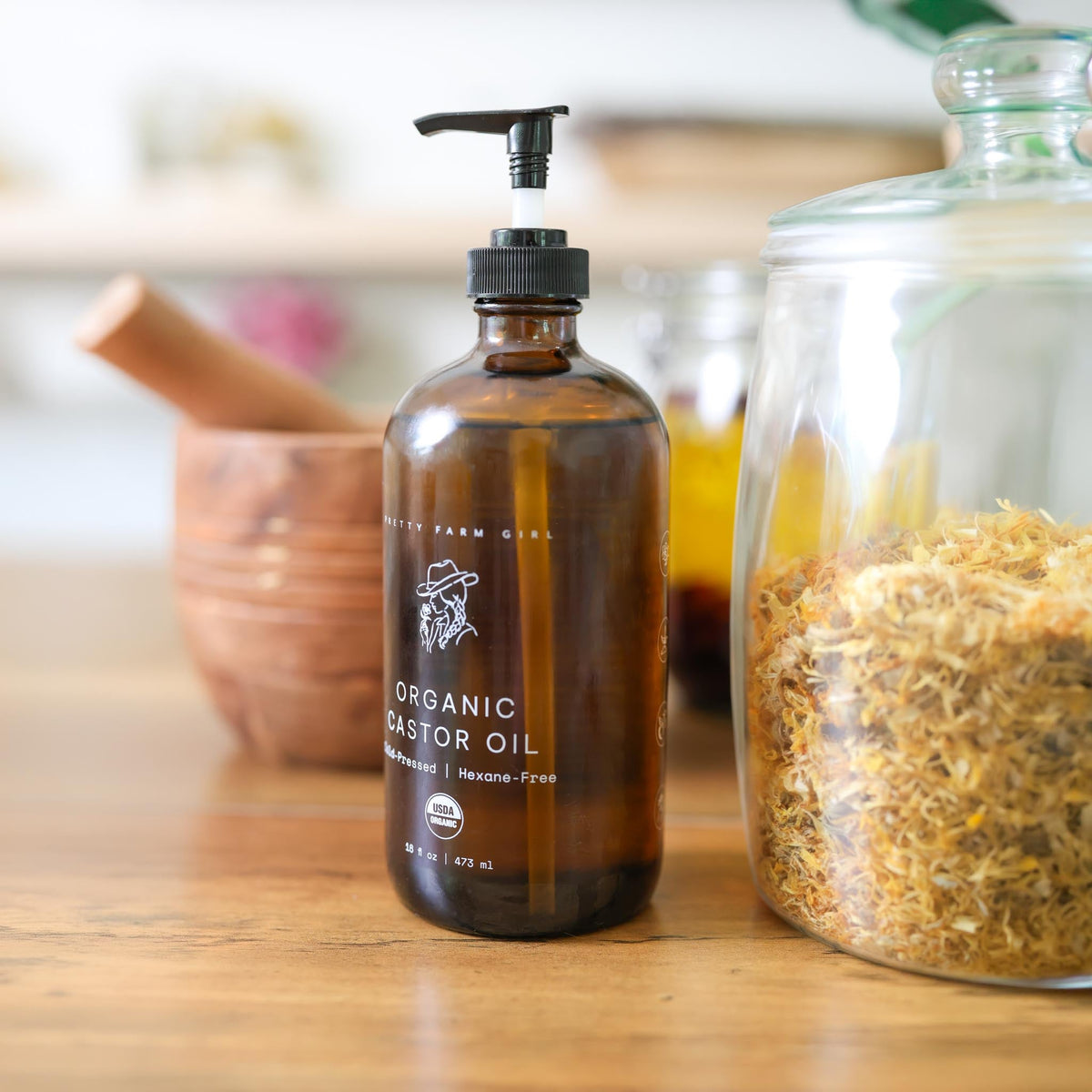 Organic castor oil by Pretty Farm Girl in a 16oz pump bottle, pure cold-pressed and hexane-free for hair and skin care.