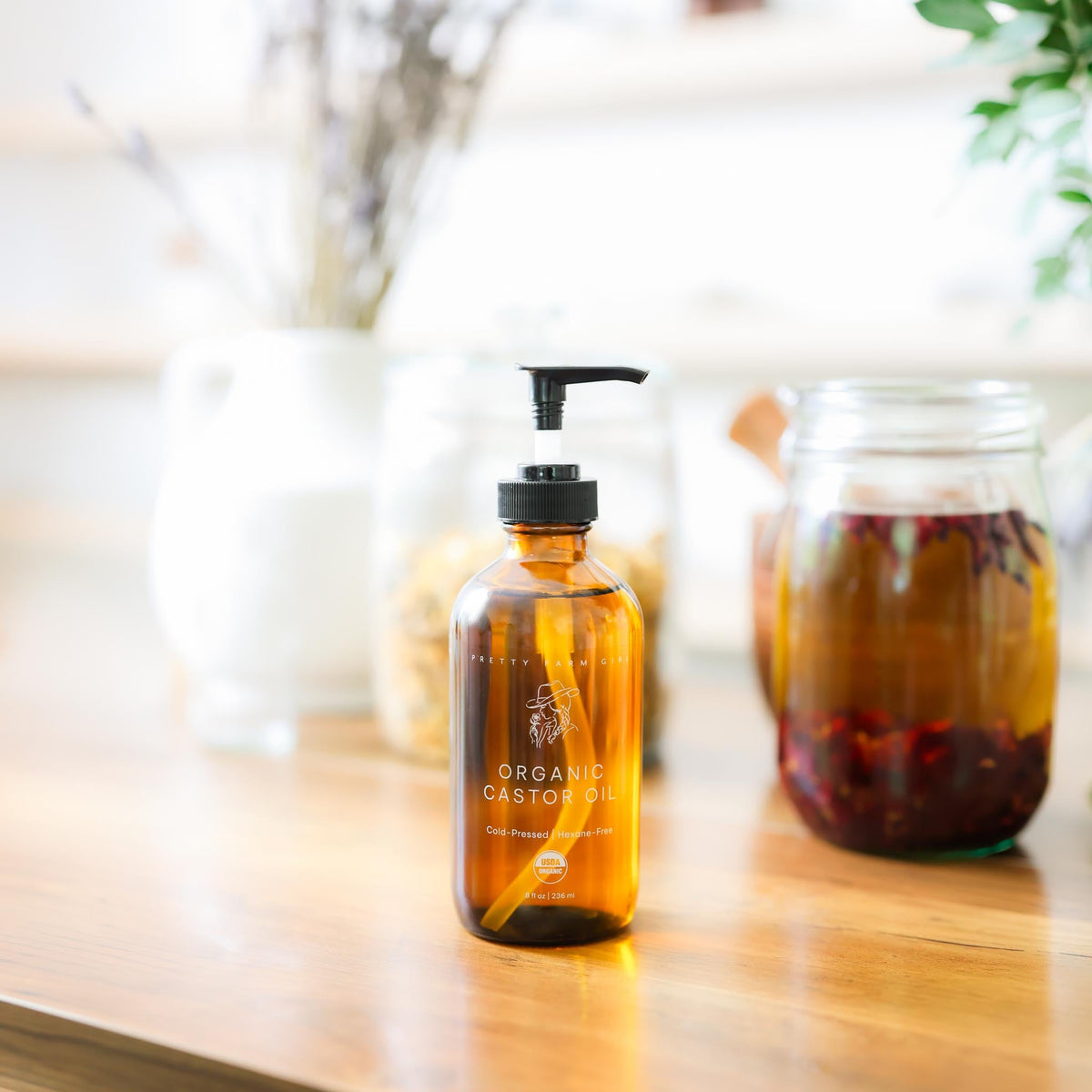 Organic castor oil by Pretty Farm Girl in an 8oz bottle with pump, cold pressed, hexane-free, suitable for skincare and hair care.