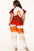 Plus size Sunset Jumpsuit by Fasheabe, stylish playsuit with vibrant sunset print, sleeveless design, and relaxed fit.
