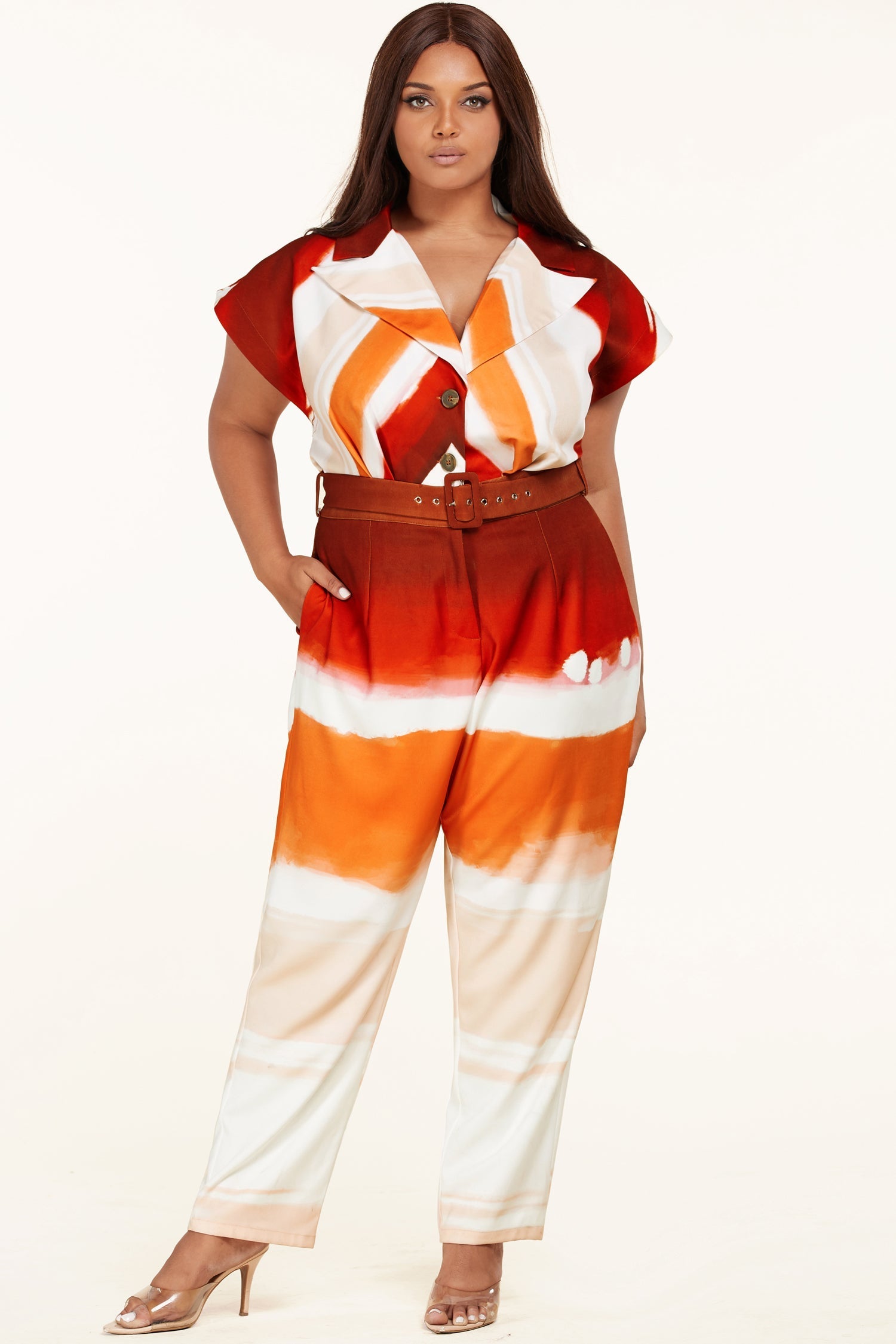 Plus size Sunset Jumpsuit by Fasheabe, stylish playsuit with vibrant sunset print, fitted waist, and sleeveless design.