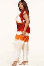 Plus size Sunset Jumpsuit by Fasheabe, vibrant playsuit with a relaxed fit and stylish design, displayed on a hanger.