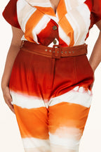 Plus size Sunset Jumpsuit by Fasheabe, stylish playsuit with flowing fabric, featuring a vibrant sunset print and wide-leg design.