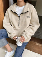 Women's half zip fleece sweatshirt with patch detail and drop shoulder design by Plush Fashion Hub.
