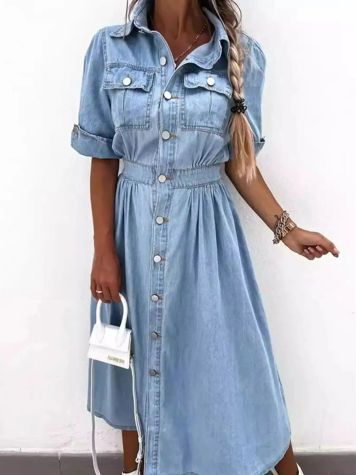 Plus size denim shirt dress with roll-up sleeves and front pockets, styled casually, from Plush Fashion Hub.