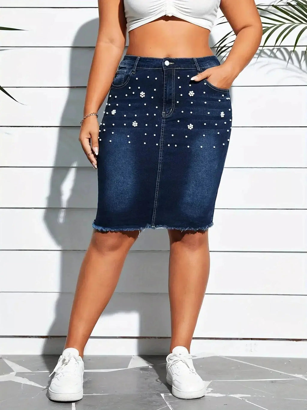 Plus size pearl-embellished frayed hem denim skirt by Trendsi, showcasing stylish denim fabric with decorative pearl details.