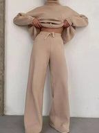 Plus size turtleneck long sleeve sweater and pants two-piece lounge set by Trendsi, shown on a model. Comfortable, casual clothing.