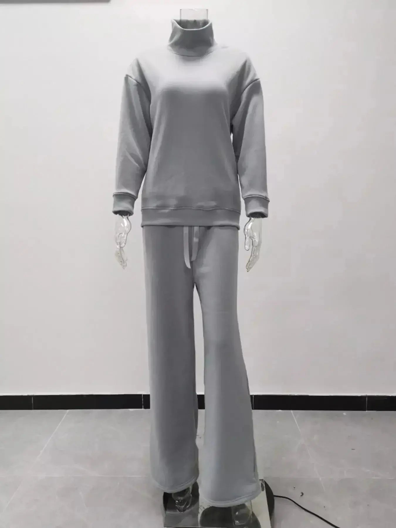Plus size turtleneck long sleeve sweater and pants two-piece lounge set by Trendsi, comfortable casual outfit for relaxed wear.