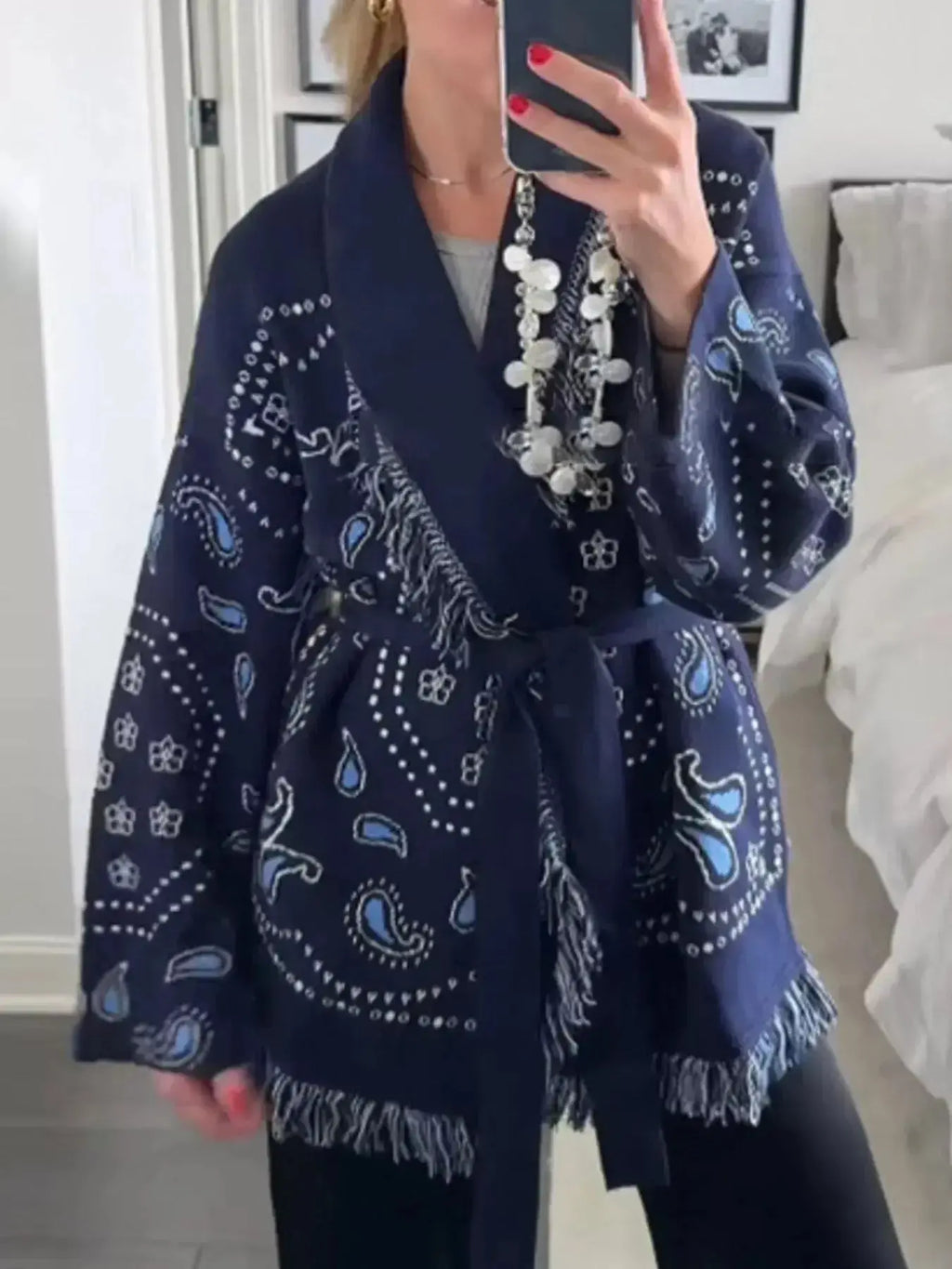 Bohemian printed fringe knit cardigan with long sleeves and tie front from Plush Fashion Hub, layered and perfect for casual wear.
