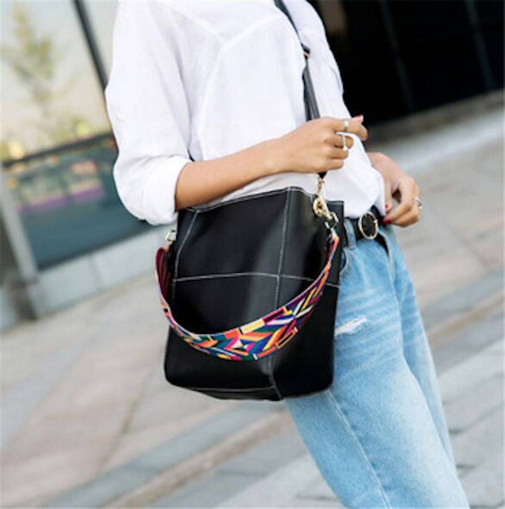 Colorful Threaded Pear Jordyn handbag with ribbon accents, bucket style, featuring a vibrant design and structured shape.