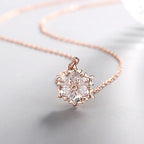 Silver snowflake necklace with diamond pendant, elegant jewelry piece featuring a delicate snowflake design and sparkling accents.