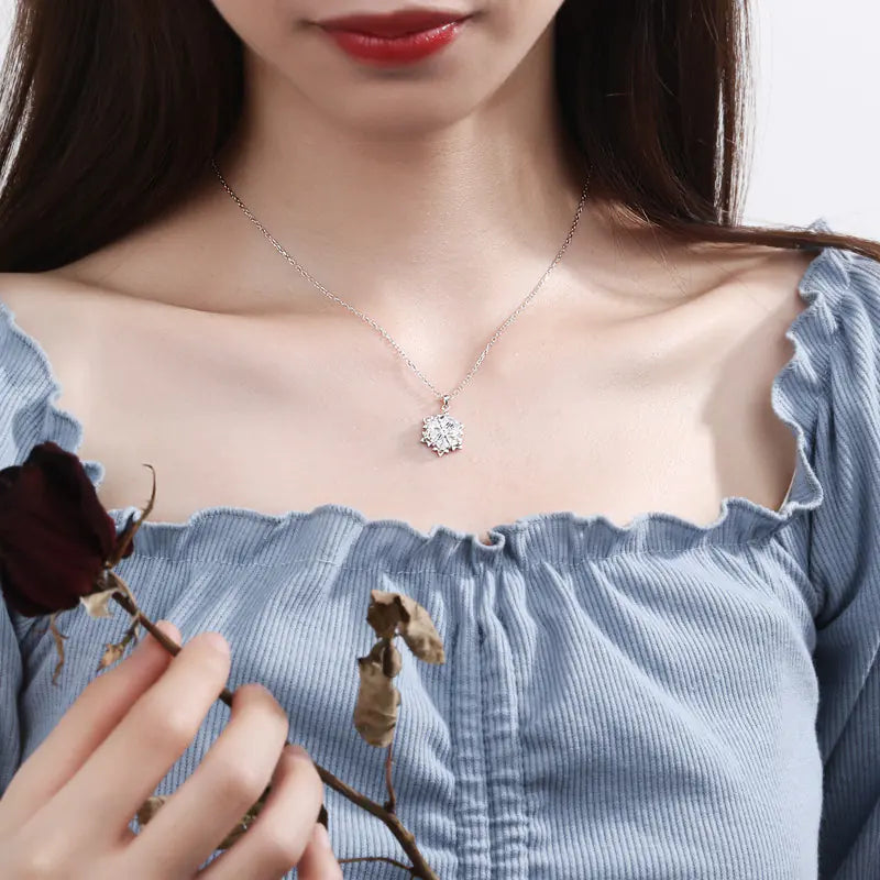 Snowflake necklace with silver chain and diamond pendant, elegant jewelry piece showcasing a sparkling winter-inspired design.