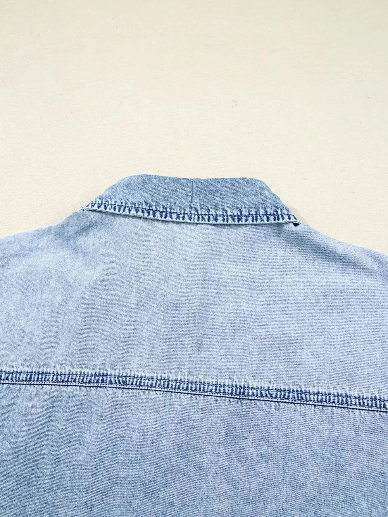 Raw hem denim button-down shirt dress with pockets, relaxed cotton fit, styled with long sleeves and casual look by Trendsi.