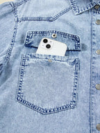Raw hem denim button-down shirt dress with pockets, relaxed cotton fit, featuring a classic denim style and casual look.