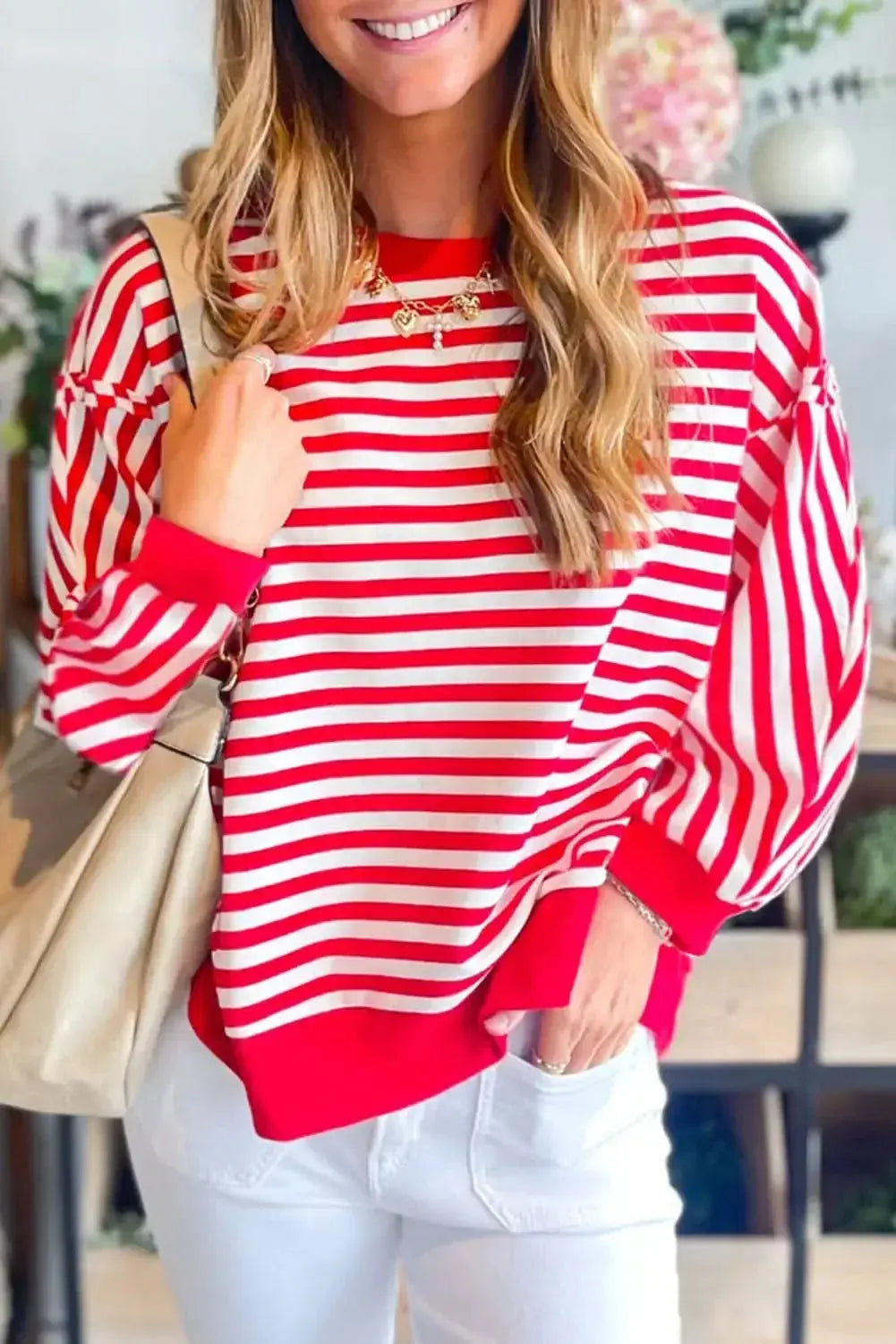 Red striped drop shoulder long sleeve top with exposed seams by Plush Fashion Hub, featuring a relaxed fit and stylish design.