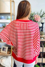 Red striped drop shoulder long sleeve top with exposed seams from Gilded Glamour Shop, featuring a relaxed fit and casual style.