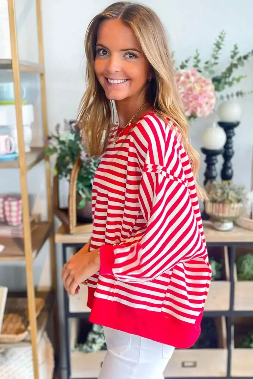 Red striped drop shoulder long sleeve top with exposed seams from Gilded Glamour Shop, stylish and casual for everyday wear.