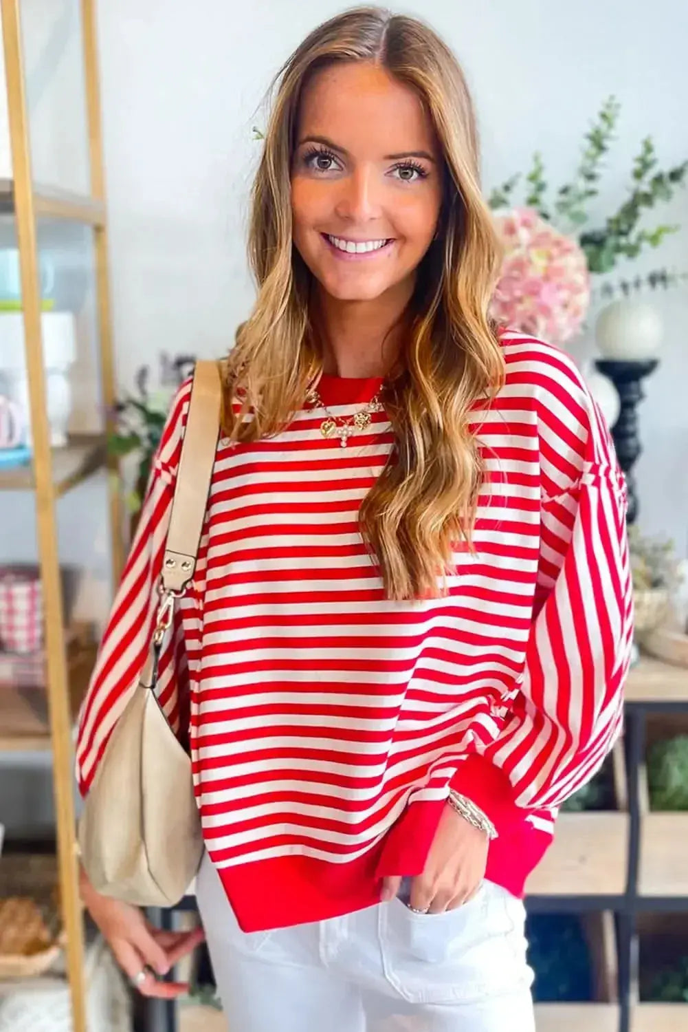 Red striped drop shoulder long sleeve top with exposed seams, stylishly designed by Gilded Glamour Shop.