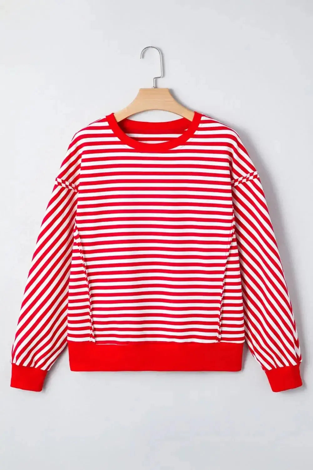 Red striped drop shoulder long sleeve top with exposed seams by Gilded Glamour Shop, casual and stylish for everyday wear.
