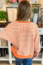 Red striped drop shoulder long sleeve top with exposed seams from Gilded Glamour Shop, featuring a relaxed fit and casual style.