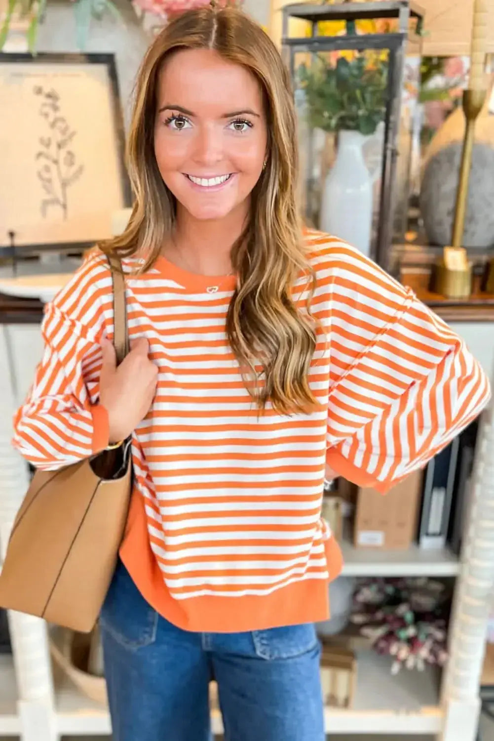 Red striped drop shoulder long sleeve top with exposed seams from Gilded Glamour Shop, featuring a relaxed fit and casual style.