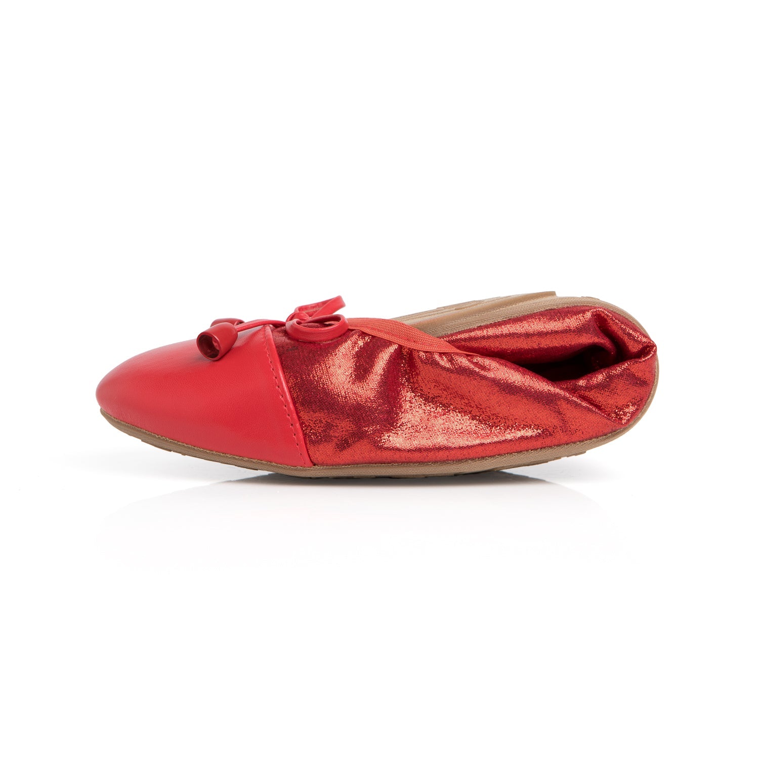 Red Talaria Flats shoes in premium ruby red, folded to showcase their sleek, comfortable design and vibrant color.