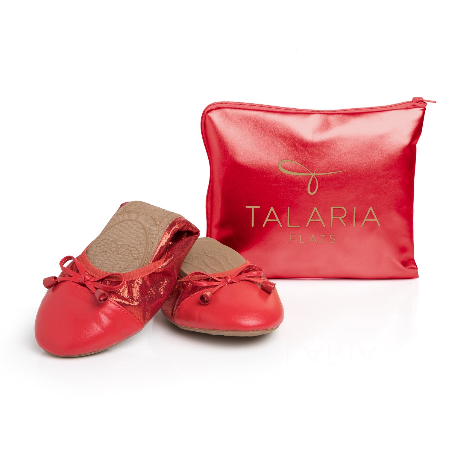 Talaria Flats premium ruby red shoes displayed in front of a bag, showcasing stylish and comfortable footwear.